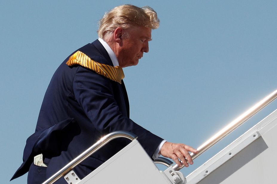 Money sticks out of Trump's back pocket as he boards Air Force One in Mountain View, California, in September 2019.
