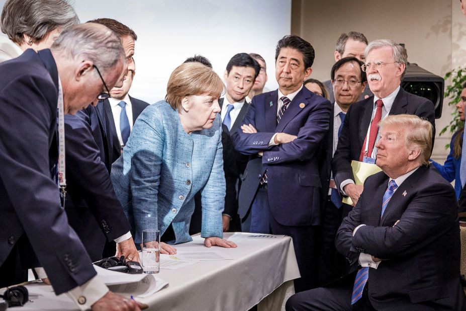 In this photo provided by the German Government Press Office, German Chancellor Angela Merkel talks with a seated Trump as they are surrounded by other leaders at the G7 summit in Charlevoix, Quebec, in June 2018. According to two senior diplomatic sources, <a href=